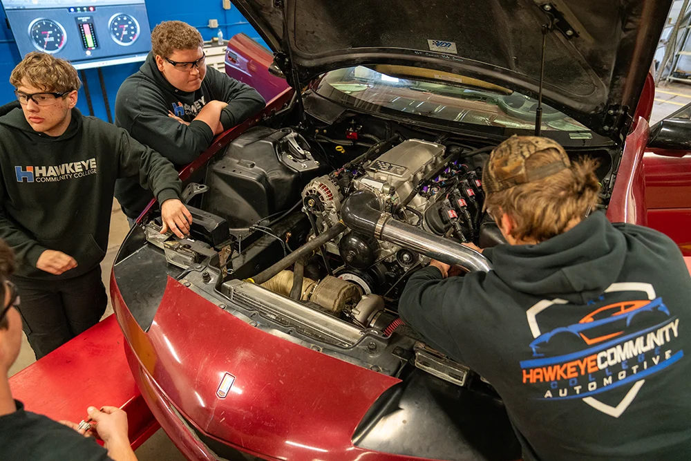 Students working on Camaro engine.