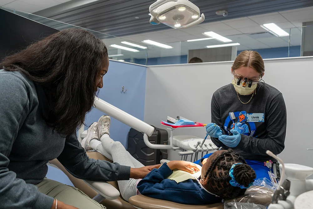 Child receives dental care at Hawkeye's Give Kids a Smile event.