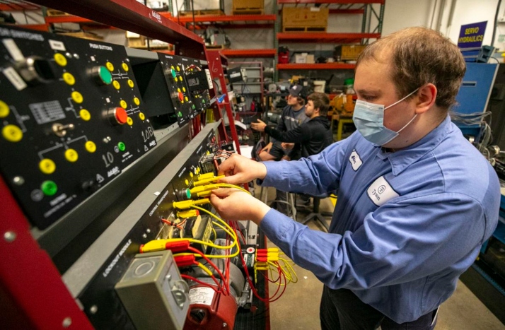 Tyson employee works on industrial maintenance equipment