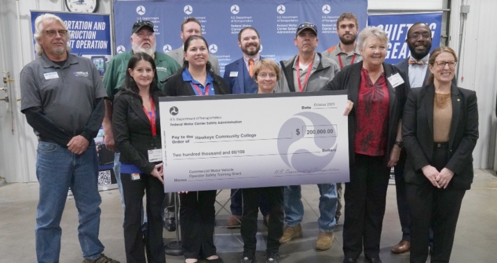  Robin Hutcheson (right), administrator of the Federal Motor Carrier Safety Administration, presents Hawkeye Community College with a check for $200,000 to support the Trucking with the Troops program that trains veterans, their spouses, and their children for careers as commercial truck drivers.